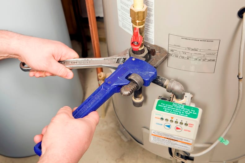 Plumber repairing a water heater valve in Lake Elsinore
